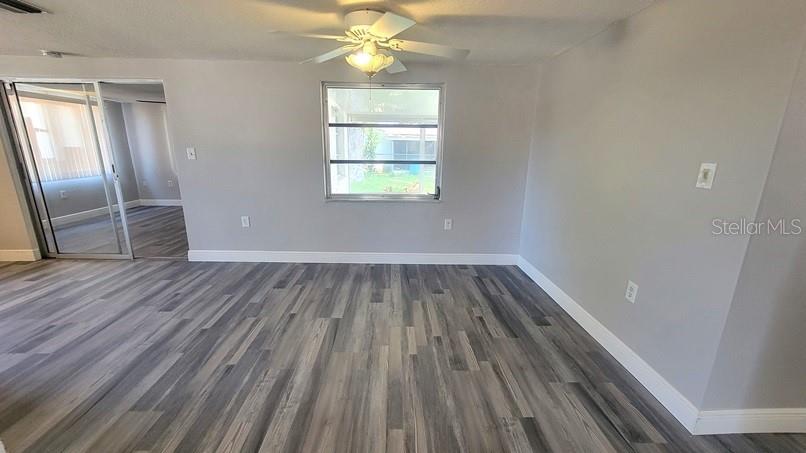 9202 Suffolk Lane Port Richey, FL 34668 - Photo 6 of 20 wooden floor in an empty room with a window