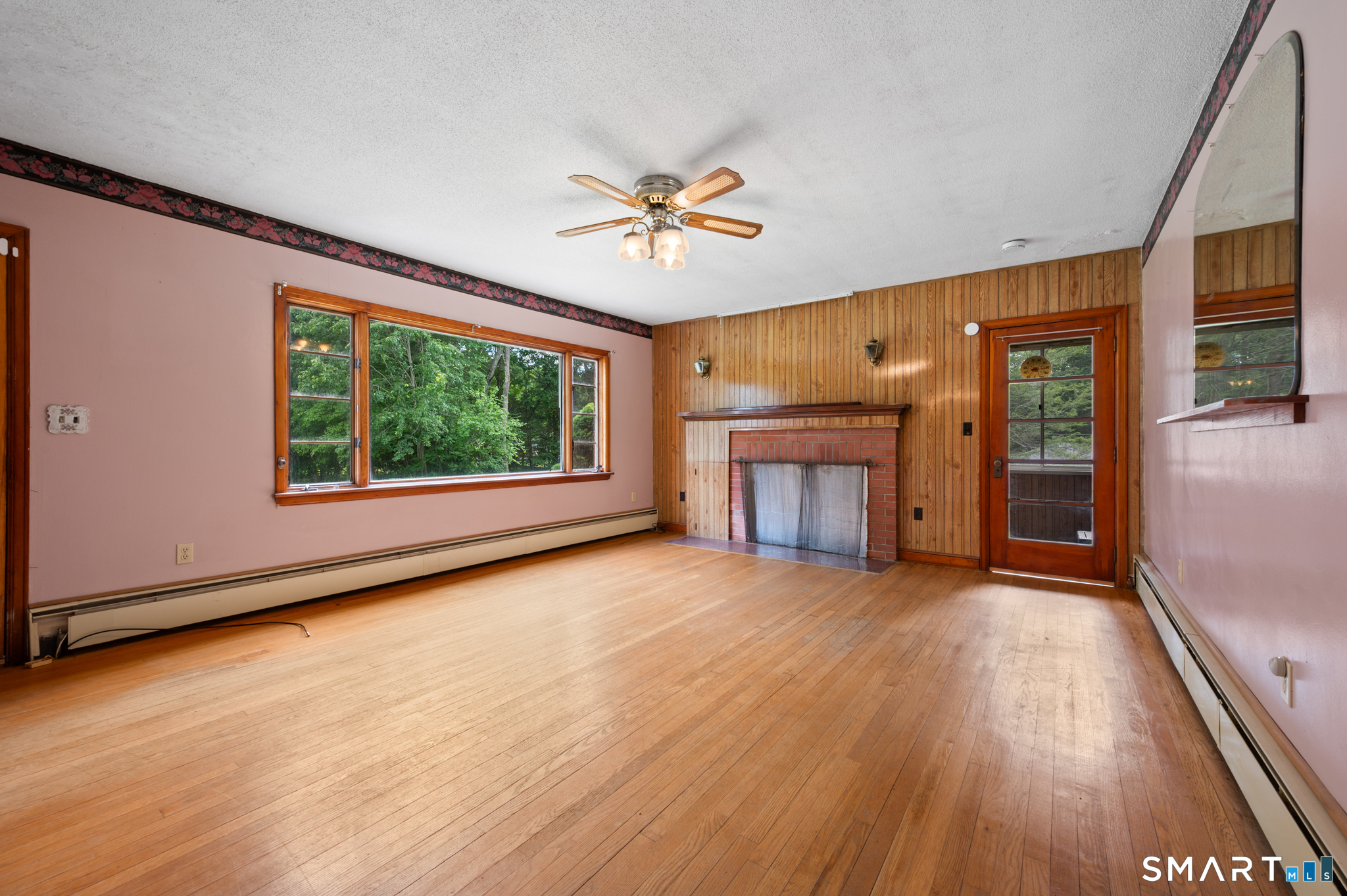 152 Ramstein Road New Hartford, CT 06057 - Photo 5 of 20 a view of an empty room with a window and wooden floor