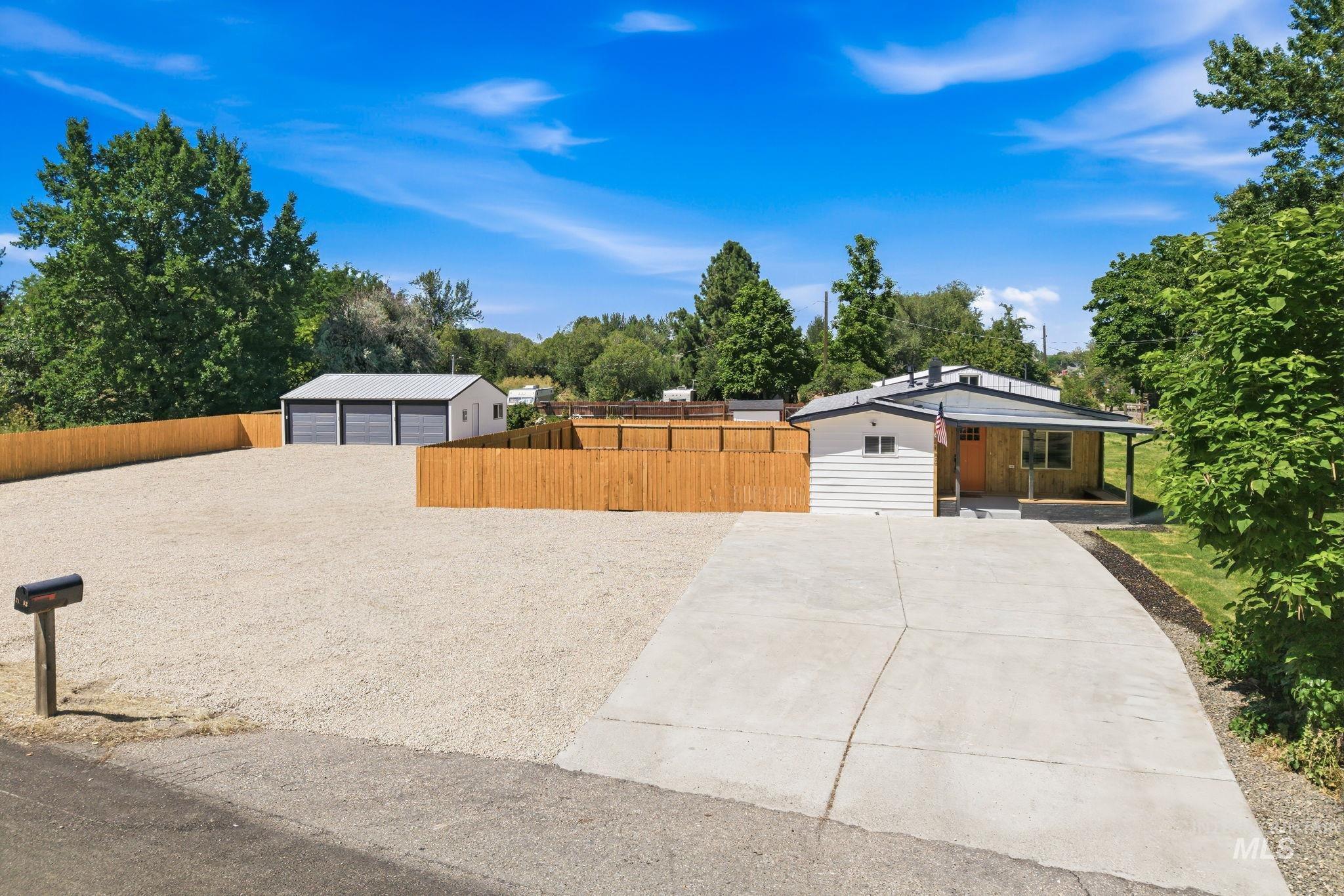 2152 Artesian Road Eagle, ID 83616 - Photo 3 of 50 Single-story residence featuring white horizontal siding and a covered front porch with wood-finish accents