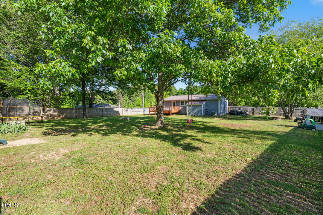 454 Cedar Creek Road Timberlake, NC 27583 - Photo 31 of 39 a view of a house with a yard
