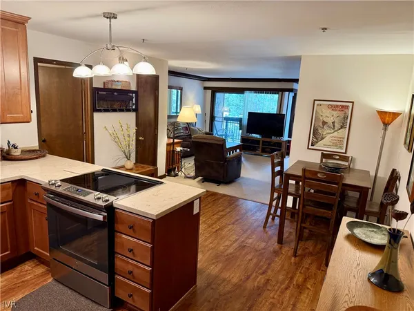 a kitchen that has a stove and a wooden floor