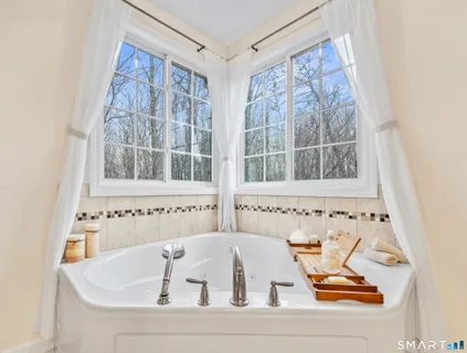 a bathroom with a bathtub and a window