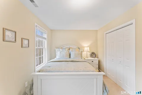 a view of a bedroom with a bed and a window