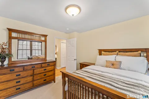 a bedroom with a bed and a dresser