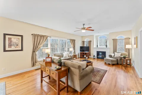 a living room with fireplace furniture and a wooden floor