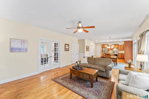 a living room with furniture and wooden floor