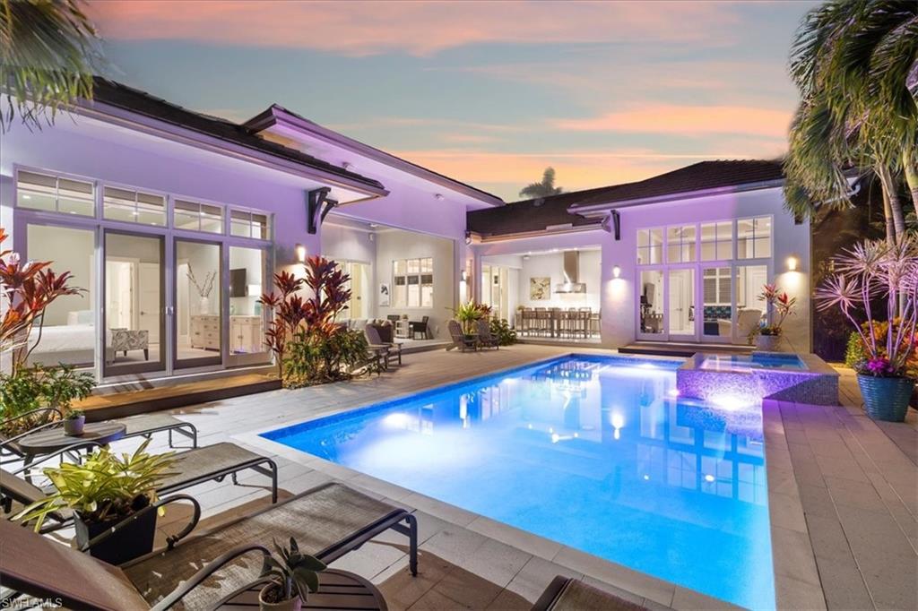 a view of a house with swimming pool and sitting area