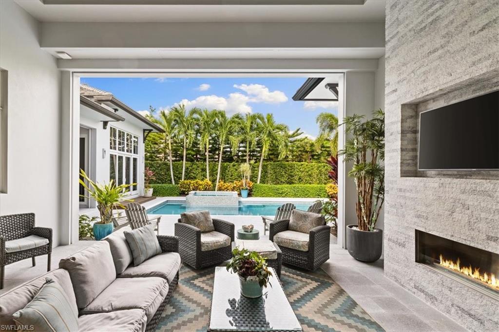 425 Harbour Drive Naples, FL 34103 - Photo 11 of 24 a living room with fireplace furniture and a flat screen tv