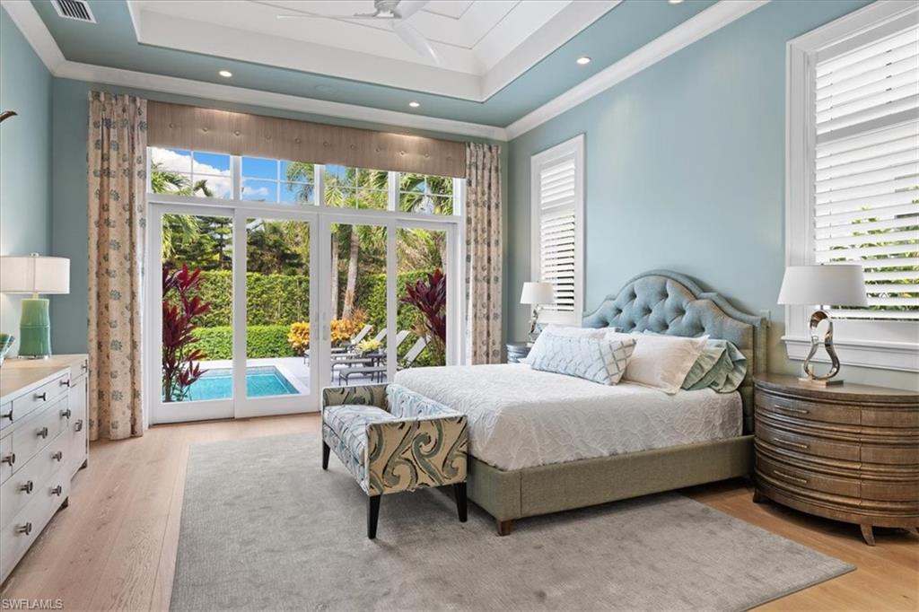 425 Harbour Drive Naples, FL 34103 - Photo 14 of 24 a bedroom with a bed and large windows