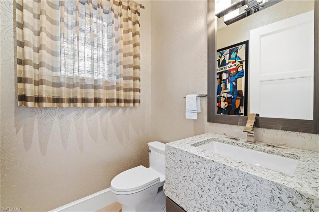 425 Harbour Drive Naples, FL 34103 - Photo 23 of 24 a bathroom with a granite countertop sink and a toilet