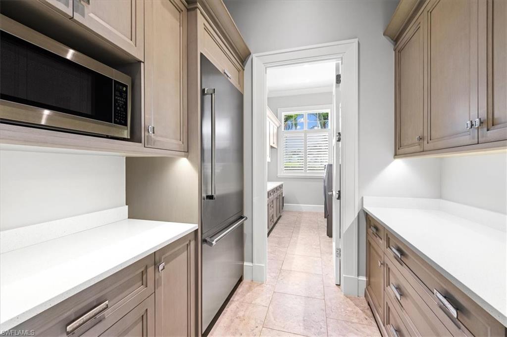 425 Harbour Drive Naples, FL 34103 - Photo 9 of 24 a kitchen with stainless steel appliances cabinets and wooden floor
