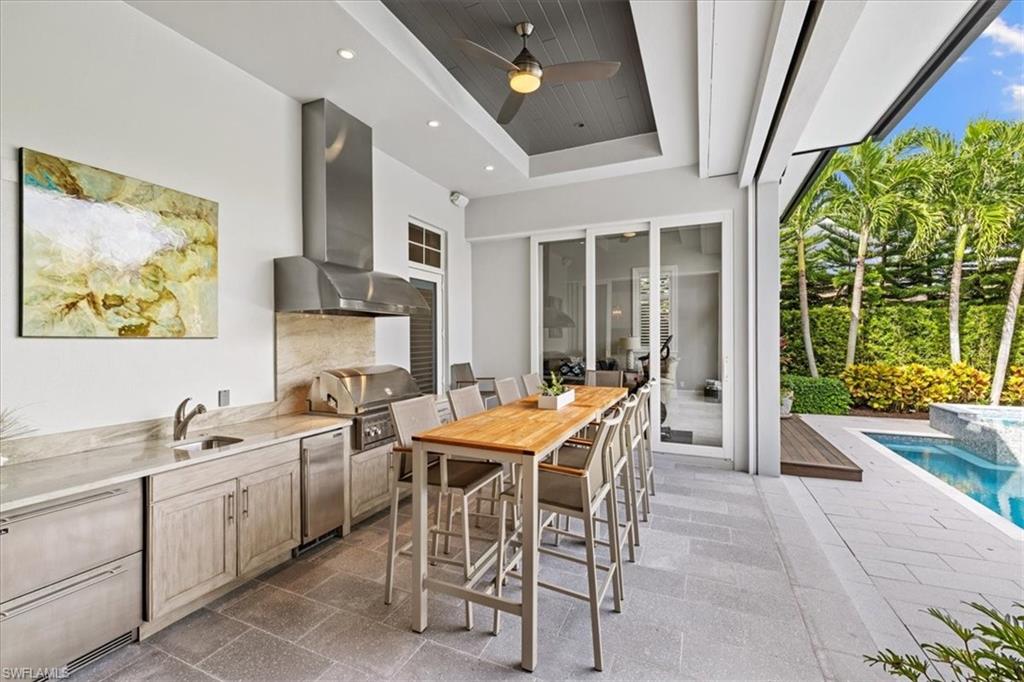 425 Harbour Drive Naples, FL 34103 - Photo 10 of 24 a view of a dining room with furniture a rug and a large window