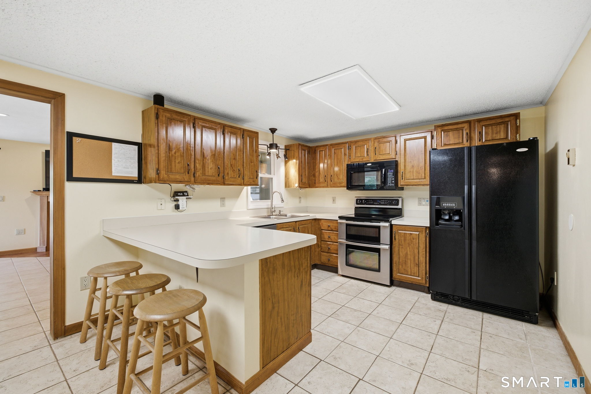 141 Hop River Road Coventry, CT 06238 - Photo 6 of 40 a kitchen with stainless steel appliances a sink stove refrigerator and cabinets