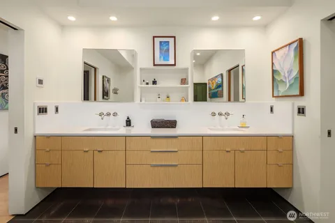 a bathroom with a double vanity sink mirror and double