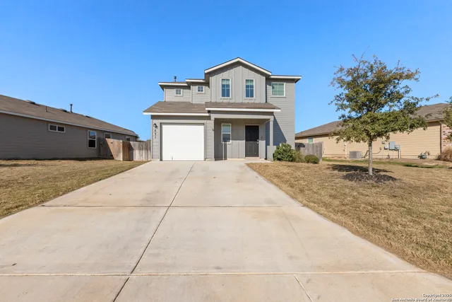 a view of house with yard and front view of a house