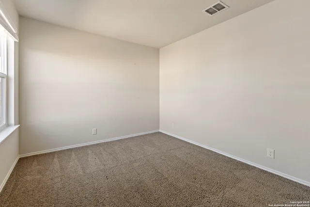 an empty room with a empty space and window