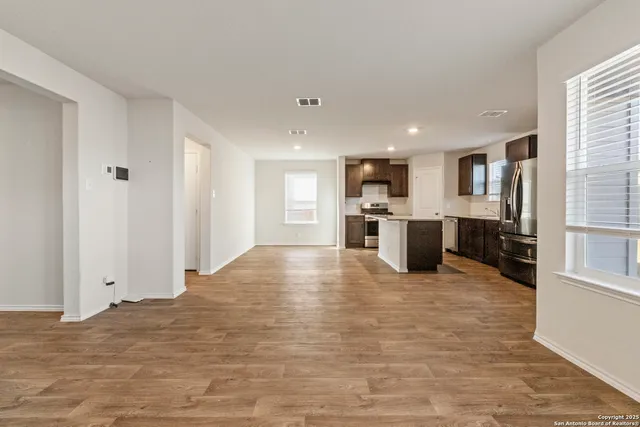 a view of kitchen with refrigerator and window