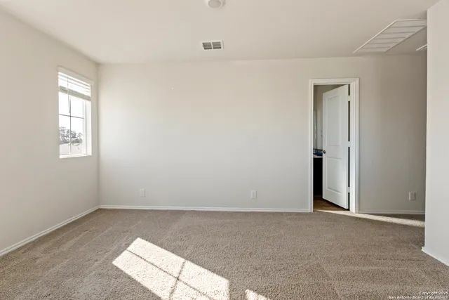 an empty room with windows and closet