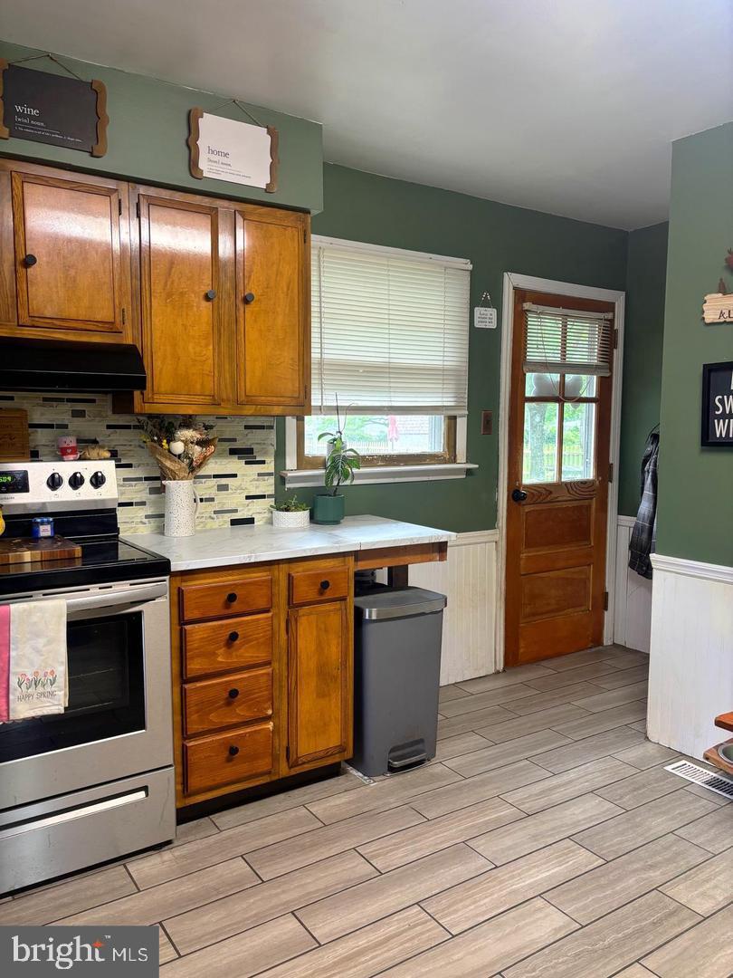 28 Pineview Terrace Bridgeton, NJ 08302 - Photo 4 of 37 a kitchen with stainless steel appliances kitchen island granite countertop a stove a sink and a microwave