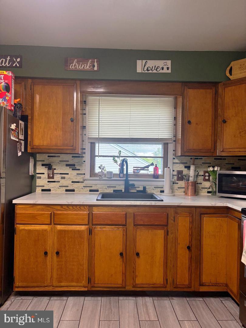 28 Pineview Terrace Bridgeton, NJ 08302 - Photo 5 of 37 a kitchen with stainless steel appliances granite countertop a sink stove and cabinets