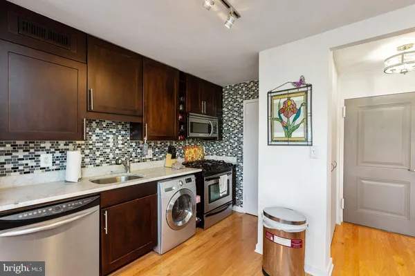 a kitchen with a sink a stove and cabinets