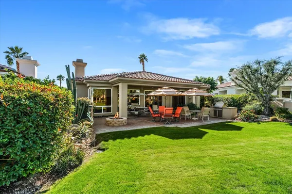 a view of a house with sitting area and garden