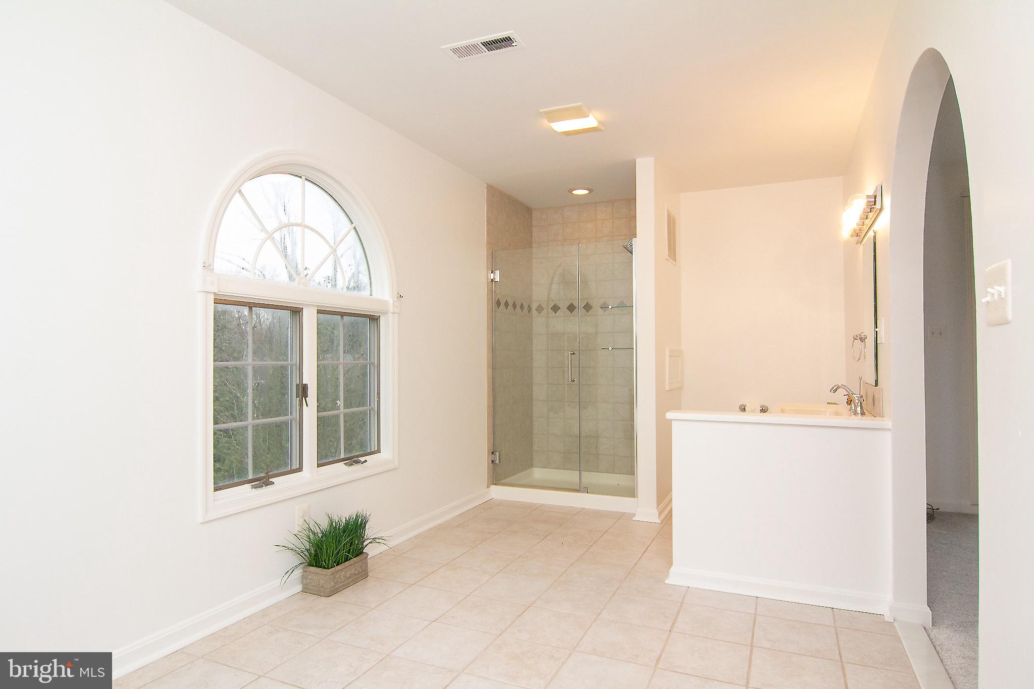 3808 Falls Road Manchester, MD 21102 - Photo 11 of 43 a view of a bathroom with a tub and shower