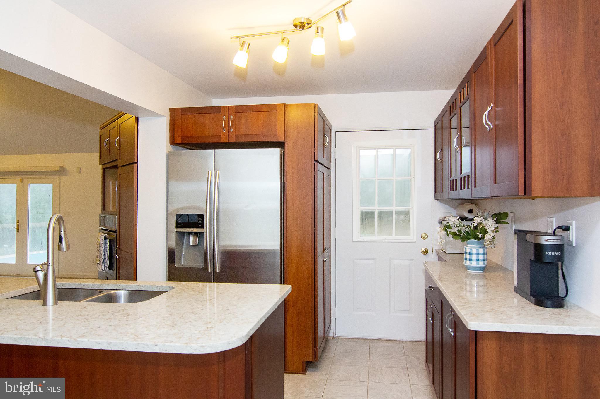 3808 Falls Road Manchester, MD 21102 - Photo 16 of 43 a kitchen with stainless steel appliances granite countertop a sink a stove and a refrigerator