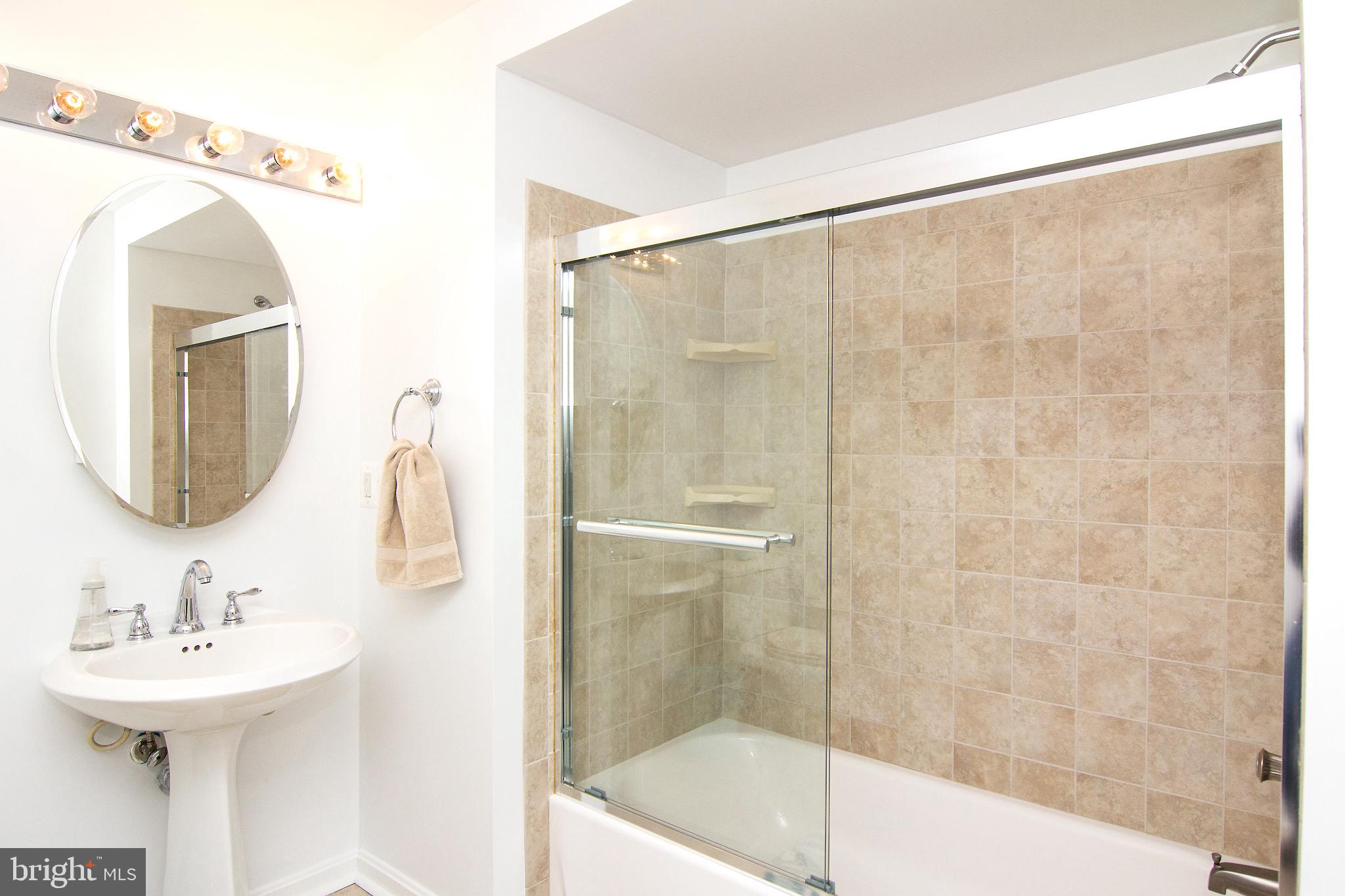 3808 Falls Road Manchester, MD 21102 - Photo 24 of 43 a bathroom with a sink a mirror and a shower