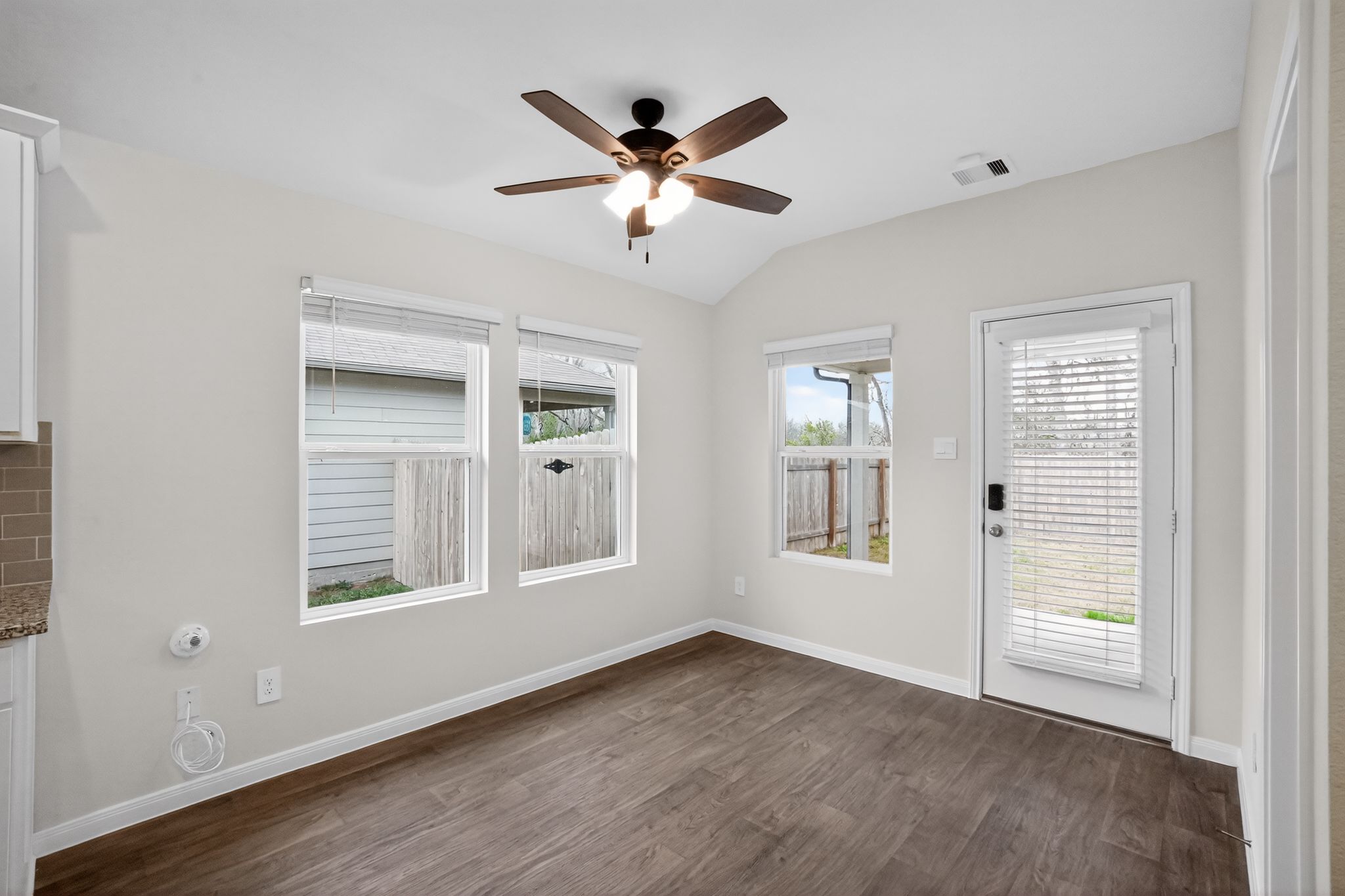 206 Addison Place Lockhart, TX 78644 - Photo 12 of 24 a view of an empty room with wooden floor and a window