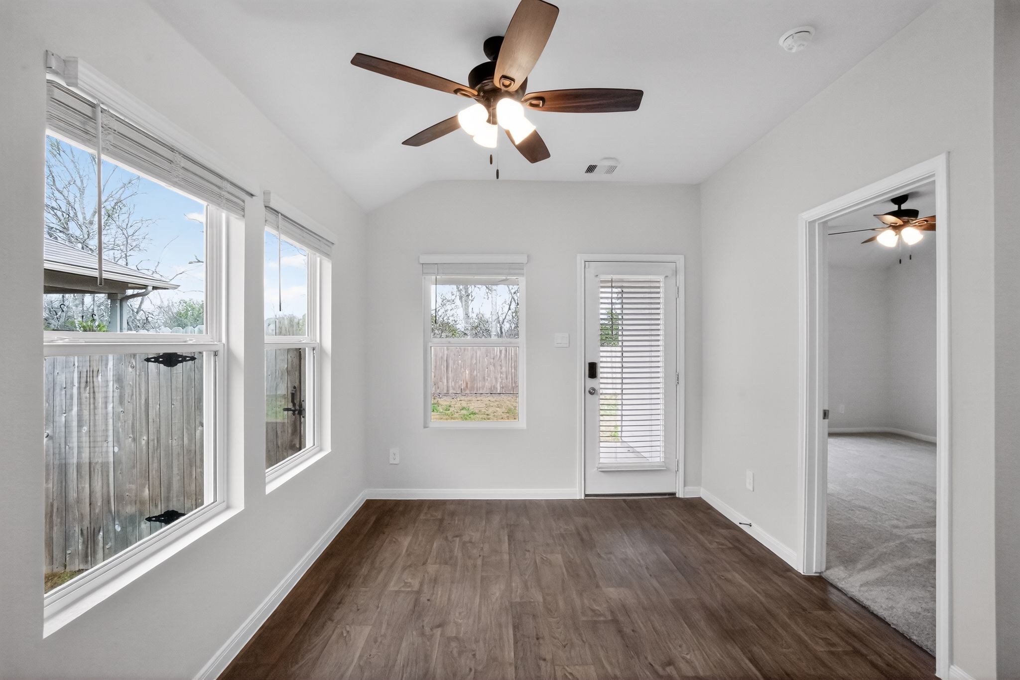 206 Addison Place Lockhart, TX 78644 - Photo 13 of 24 wooden floor in an empty room with a window