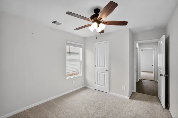 a view of a livingroom with a ceiling fan and window