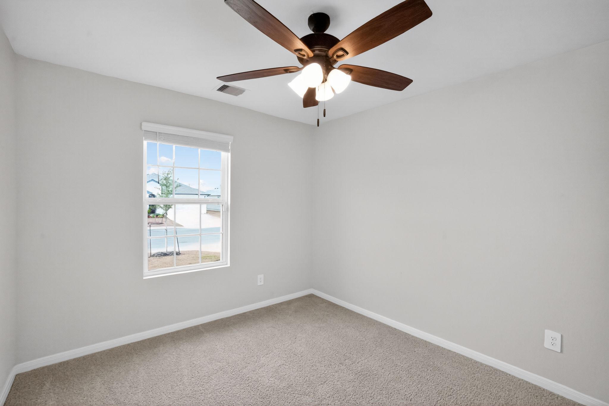 206 Addison Place Lockhart, TX 78644 - Photo 20 of 24 an empty room with a window and a fan