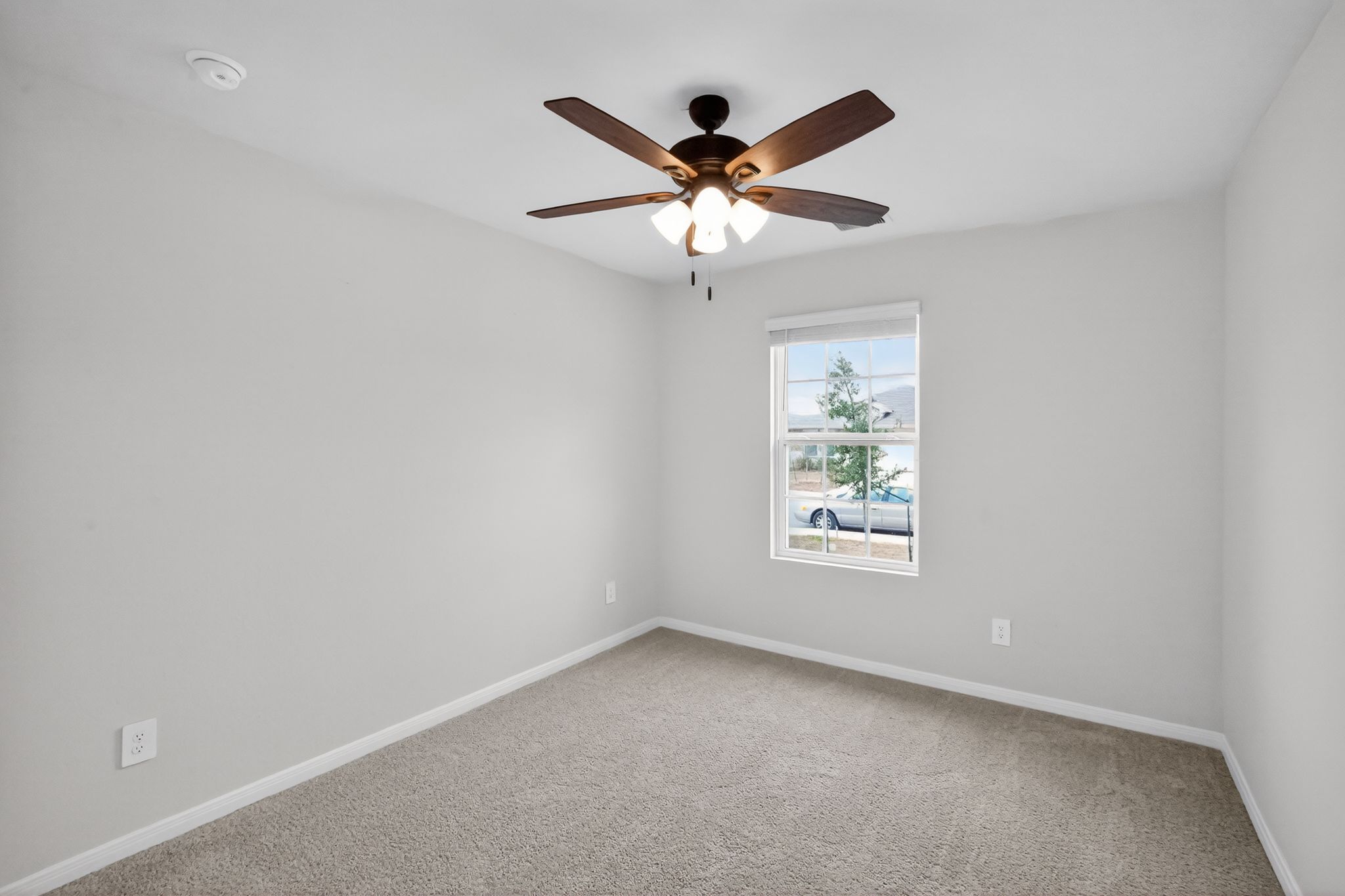 206 Addison Place Lockhart, TX 78644 - Photo 21 of 24 an empty room with window and ceiling fan