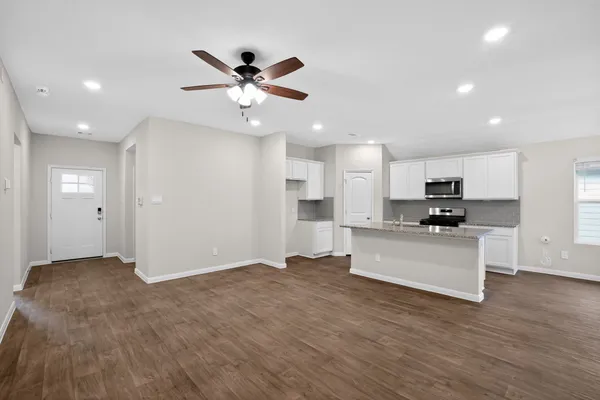 a view of kitchen with sink and refrigerator