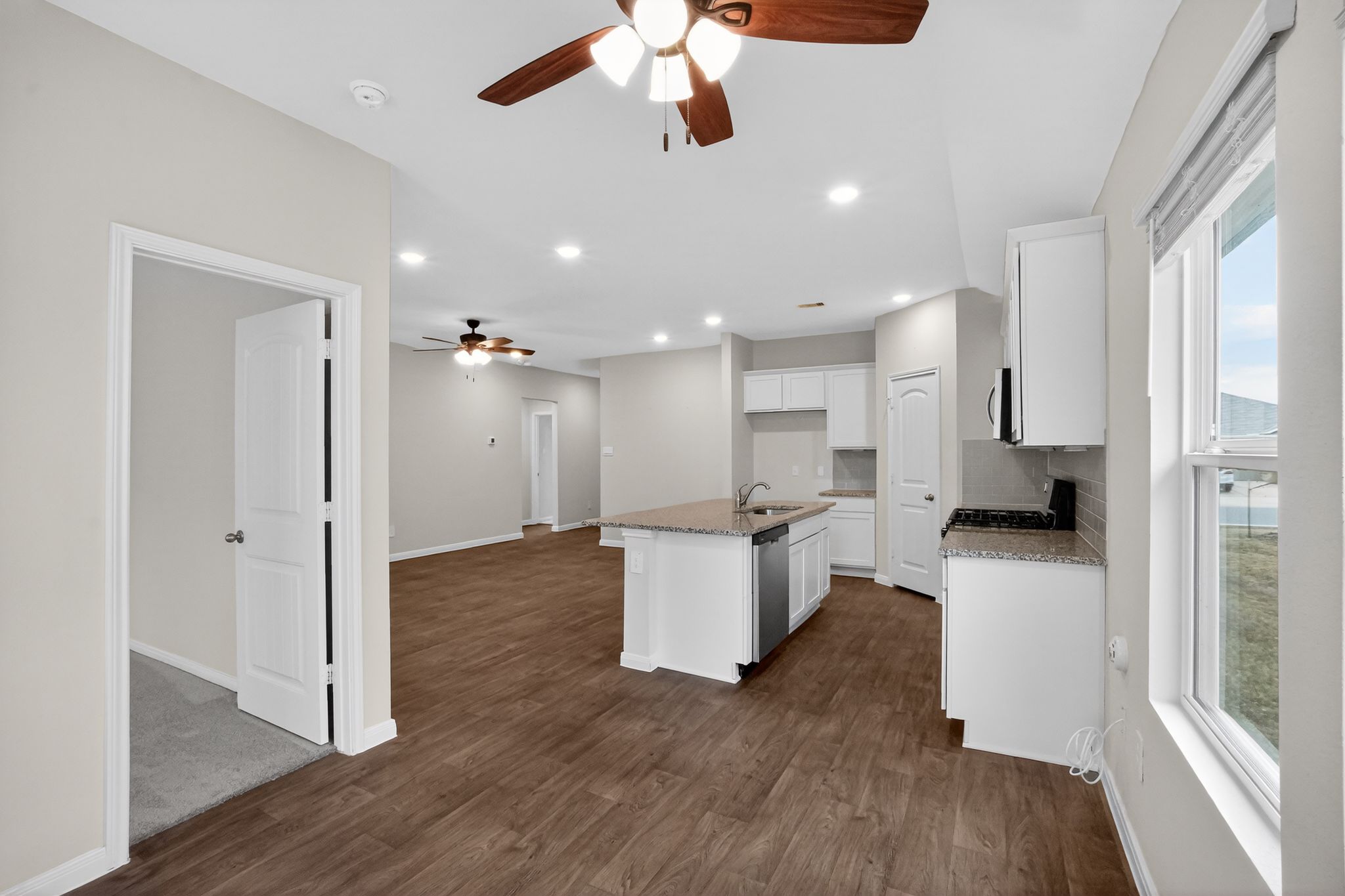 206 Addison Place Lockhart, TX 78644 - Photo 9 of 24 a kitchen with a refrigerator and white cabinets