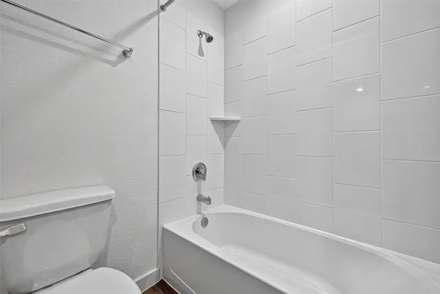 a bathroom with a toilet and a bathtub