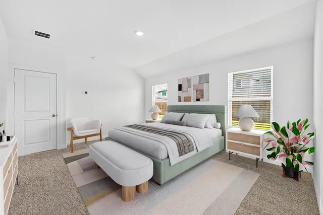 a spacious bedroom with a bed and a couch