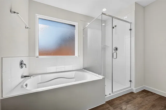 a bathroom with a tub a sink and mirror