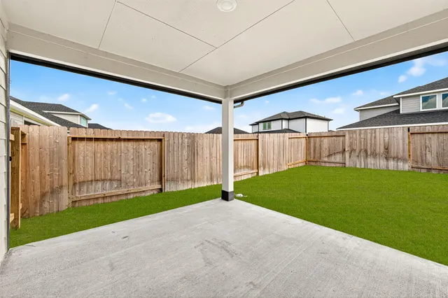 a view of a backyard with wooden fence