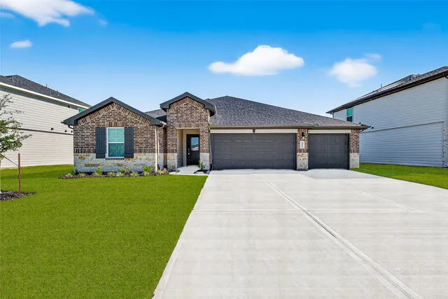 a front view of a house with a garden and yard