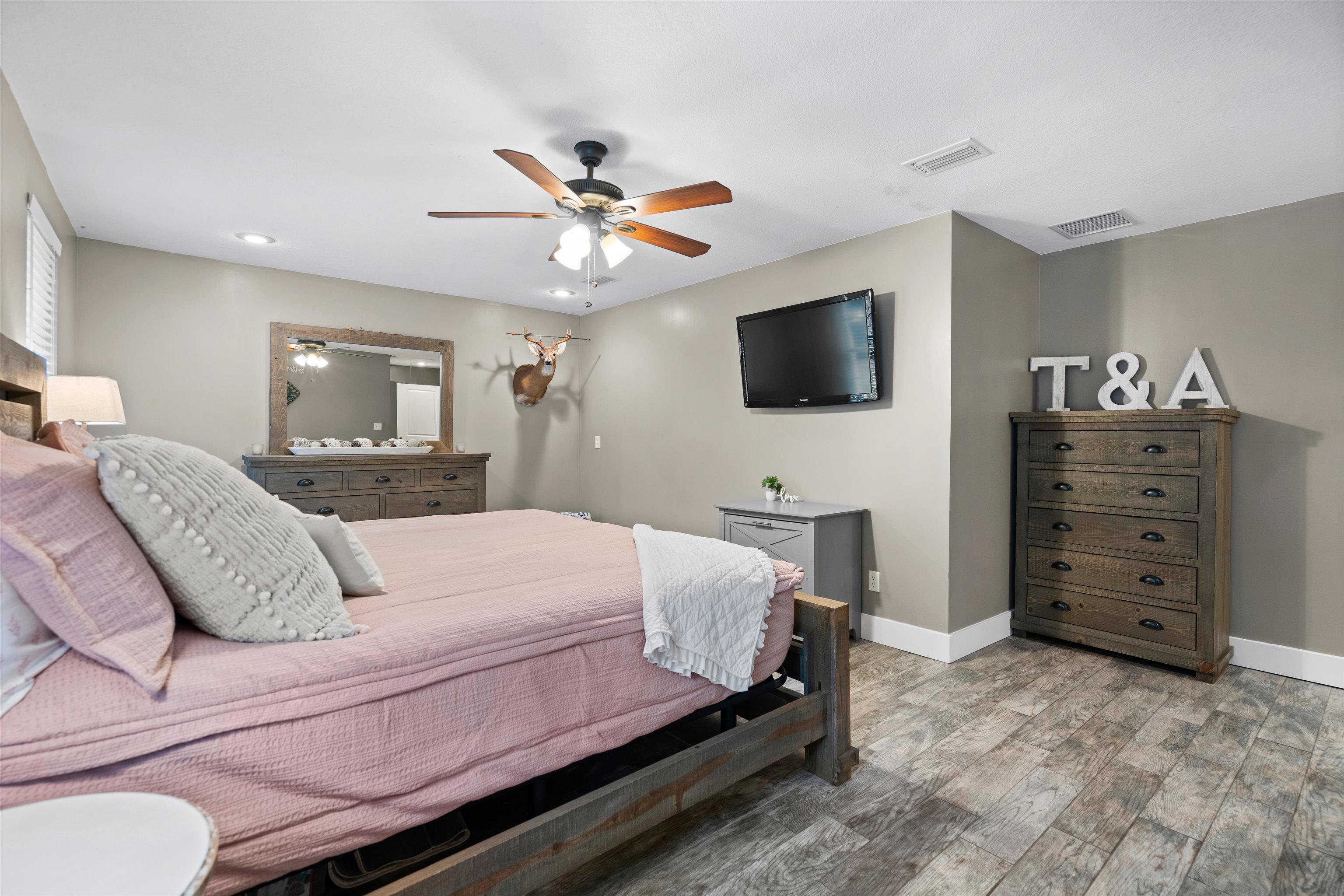 9355 Byrd Road Hastings, FL 32145 - Photo 26 of 59 a bedroom with a large bed and a flat screen tv