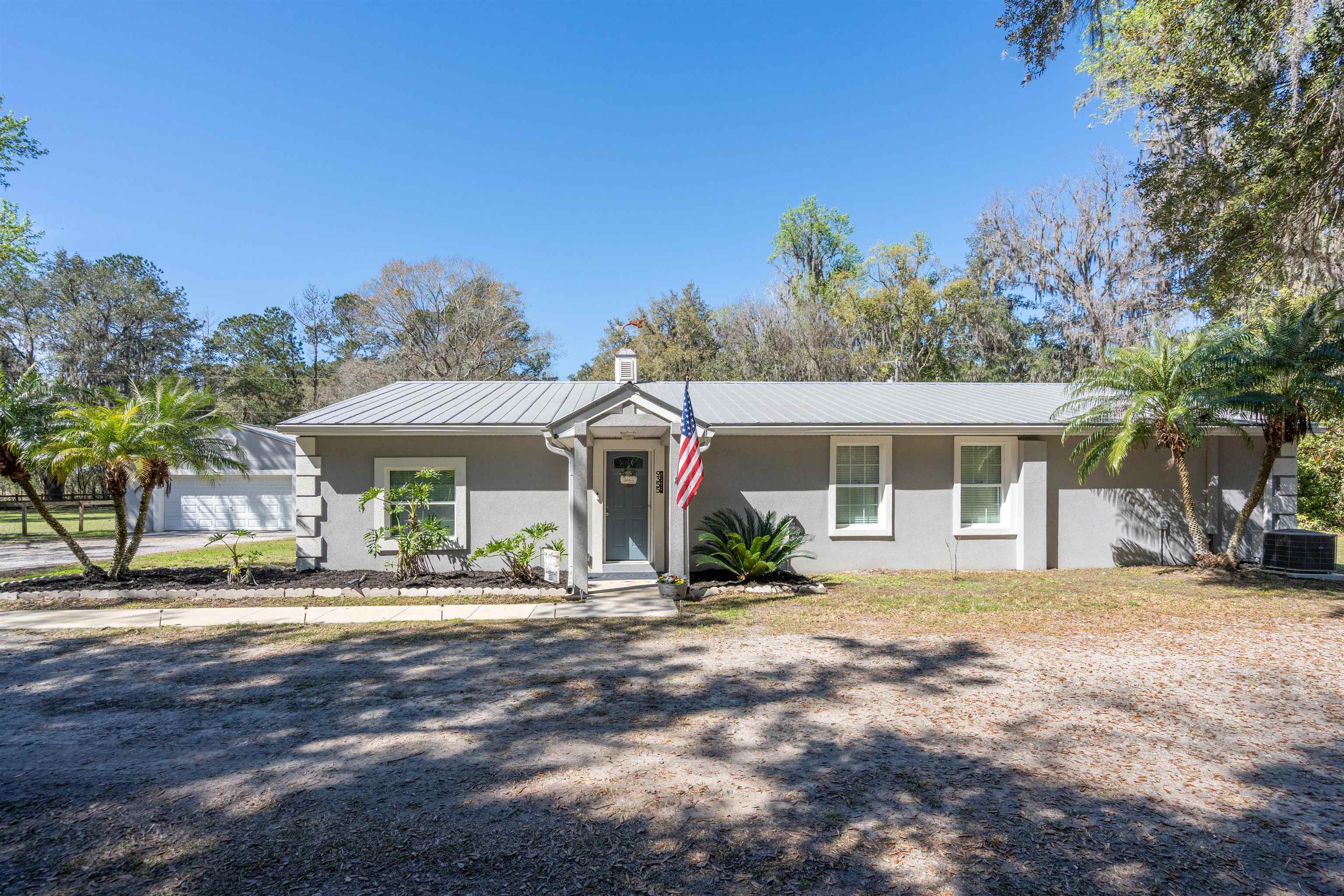 9355 Byrd Road Hastings, FL 32145 - Photo 3 of 59 a front view of house with yard and trees in the background