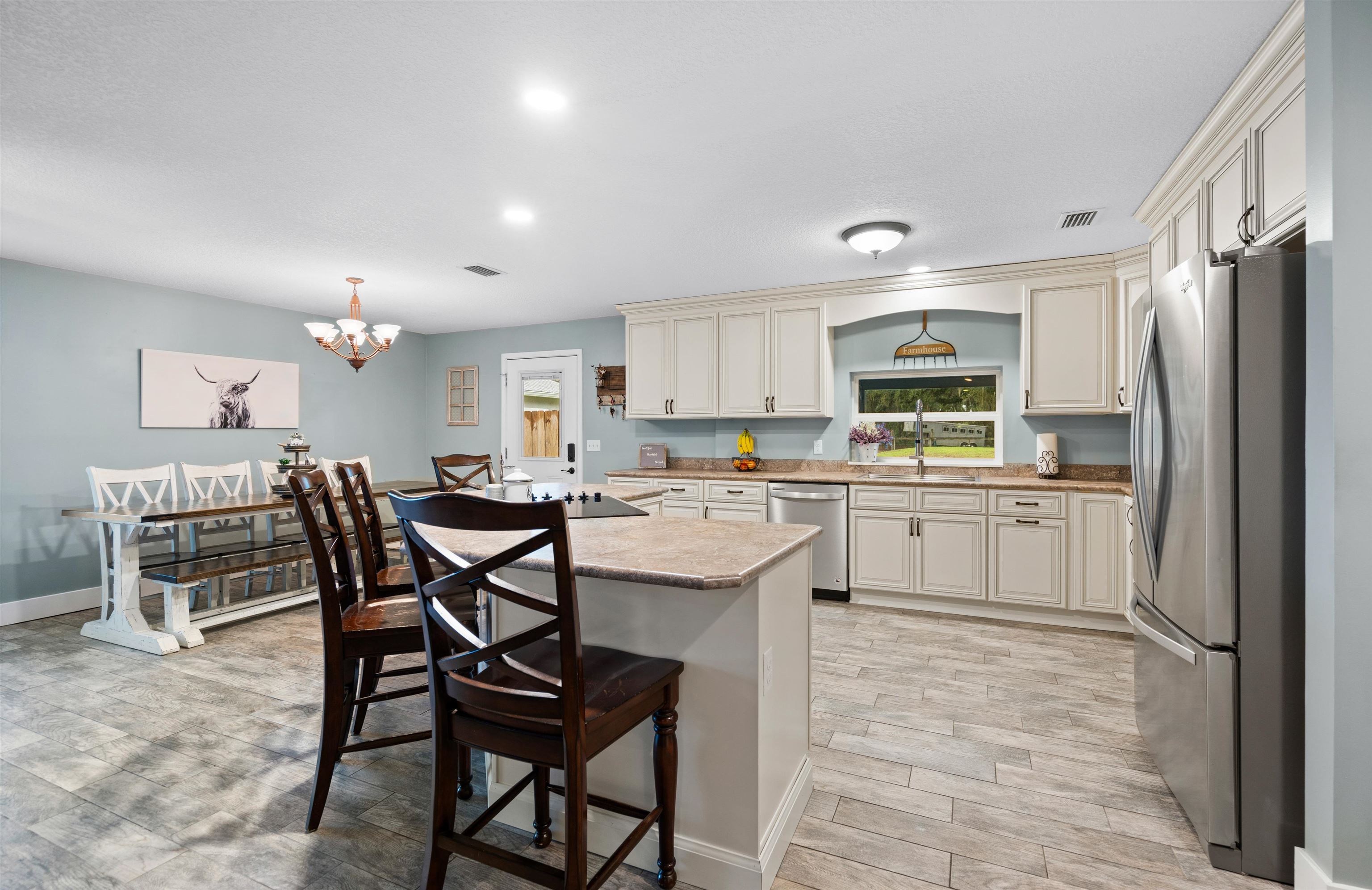 9355 Byrd Road Hastings, FL 32145 - Photo 10 of 59 a kitchen with white cabinets and stainless steel appliances