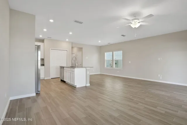 a bathroom with a granite countertop sink a toilet and a mirror