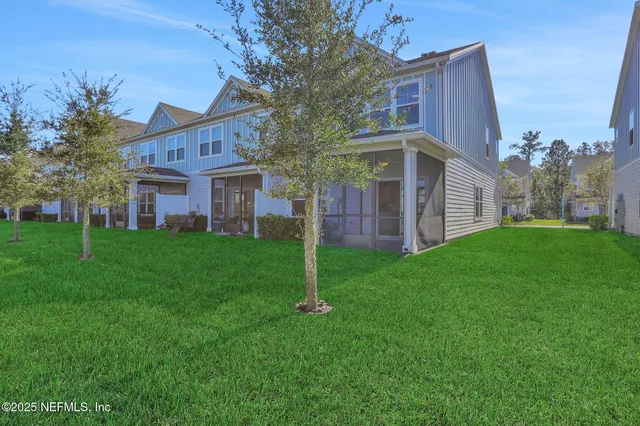 a kitchen with white cabinets and appliances