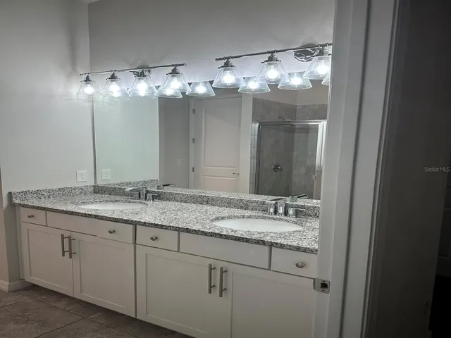 a bathroom with a sink and mirror
