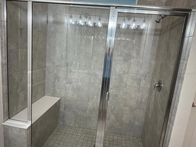 a bathroom with a glass shower door