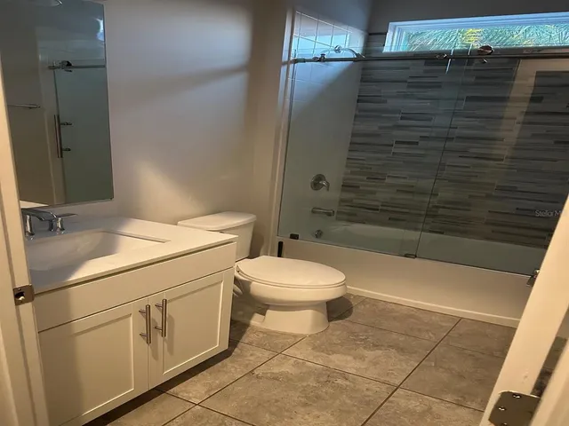 a bathroom with a toilet a sink and shower