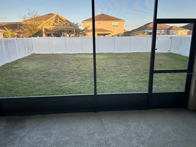 a view of a back yard from a balcony